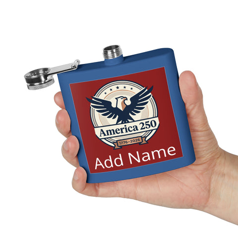Blue flask with red label featuring an eagle emblem and text, held in a hand against a white background.