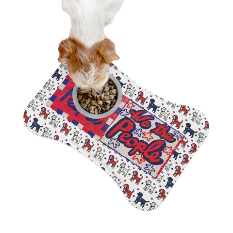 Patriotic "We The People" pet feeding mat in red, white, and blue calligraphy with star designs, ideal for pet feeding areas.